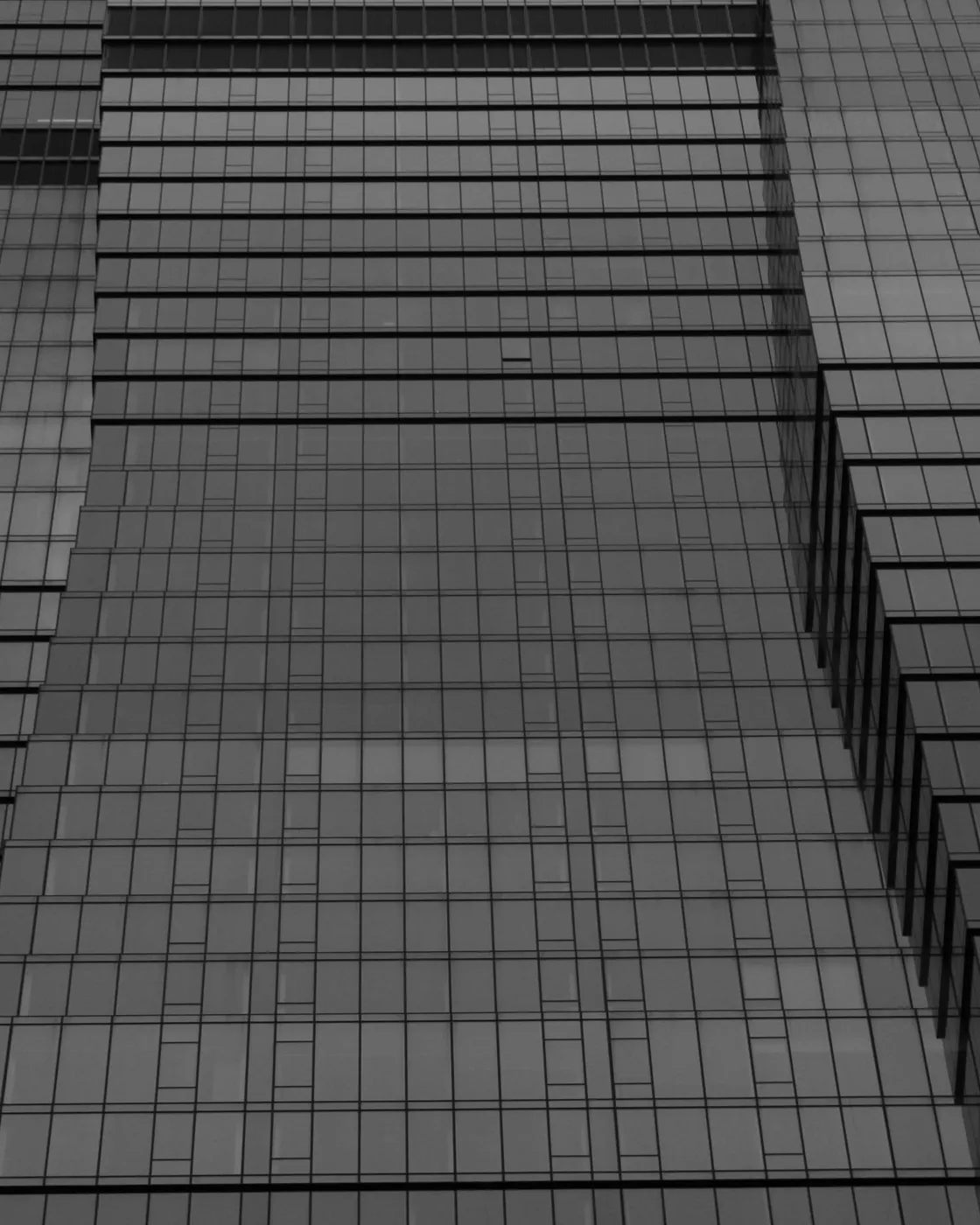 Fachada de vidro de um edifício corporativo, em preto e branco